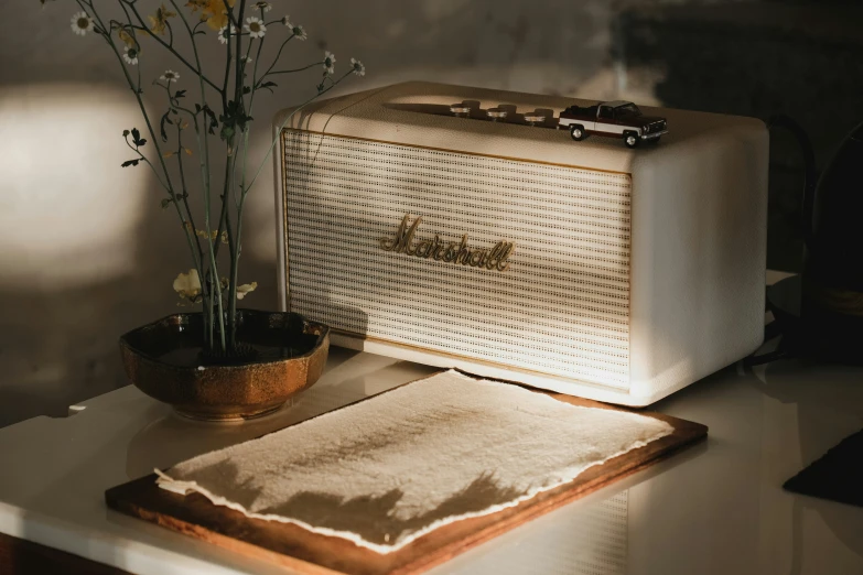 a white radio is sitting on a desk