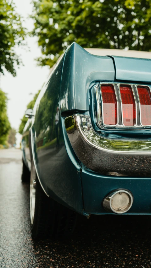 there is a rear view of a blue mustang mustang