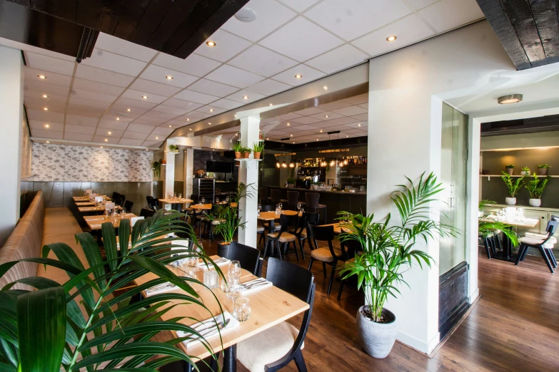 the interior of a restaurant with wooden floors