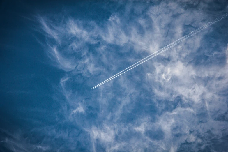 an airplane is flying through a cloudless sky