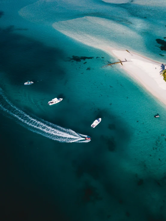 some boats are in the water next to the shore