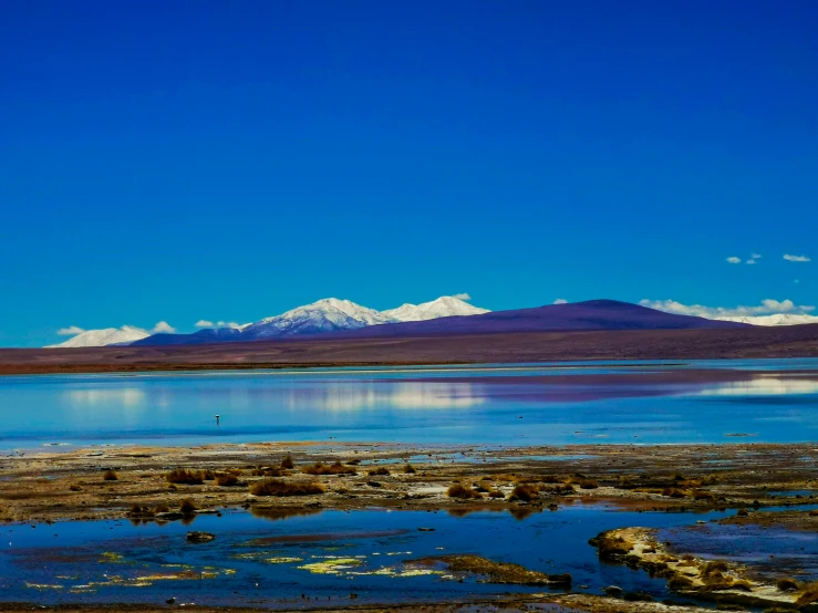 the water looks like a lake with mountains in the background