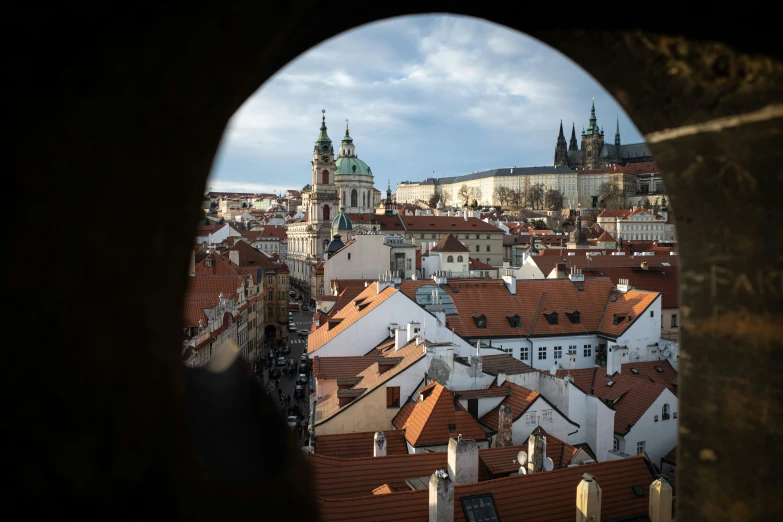 the view of rooftops in a distance through a porthole