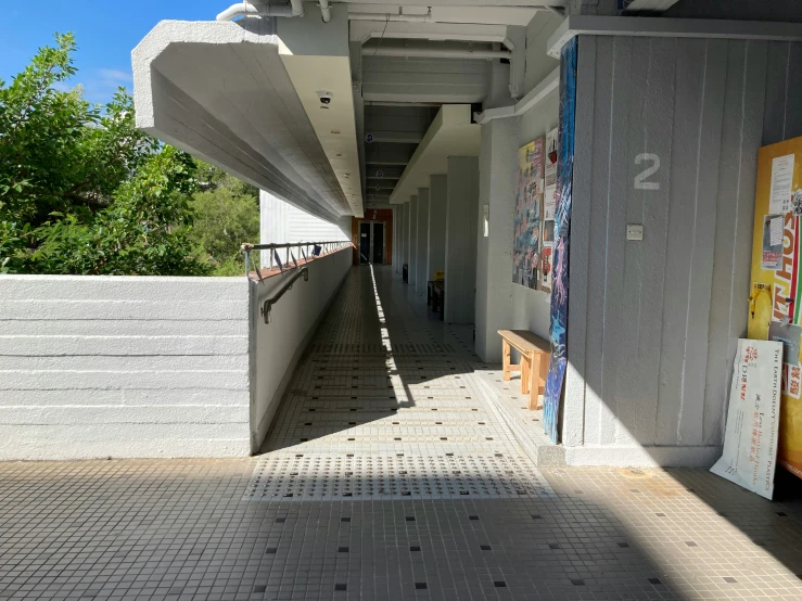 a long walkway that has lots of boards on the walls