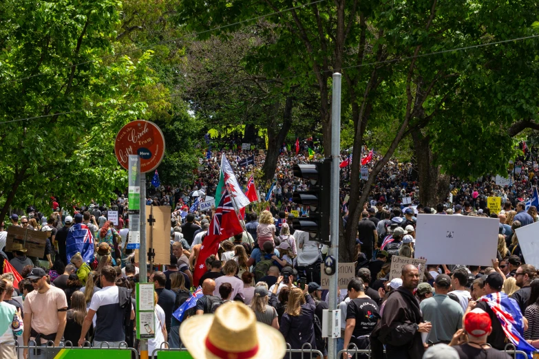 a large group of people who are walking down a street