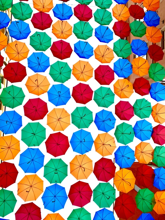 lots of different colored umbrellas are laying on the ground