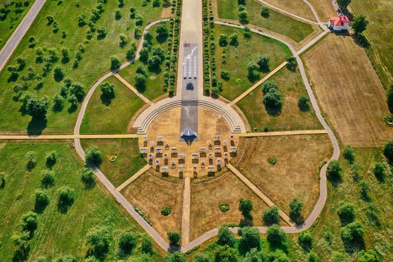 a circular area surrounded by green fields and trees