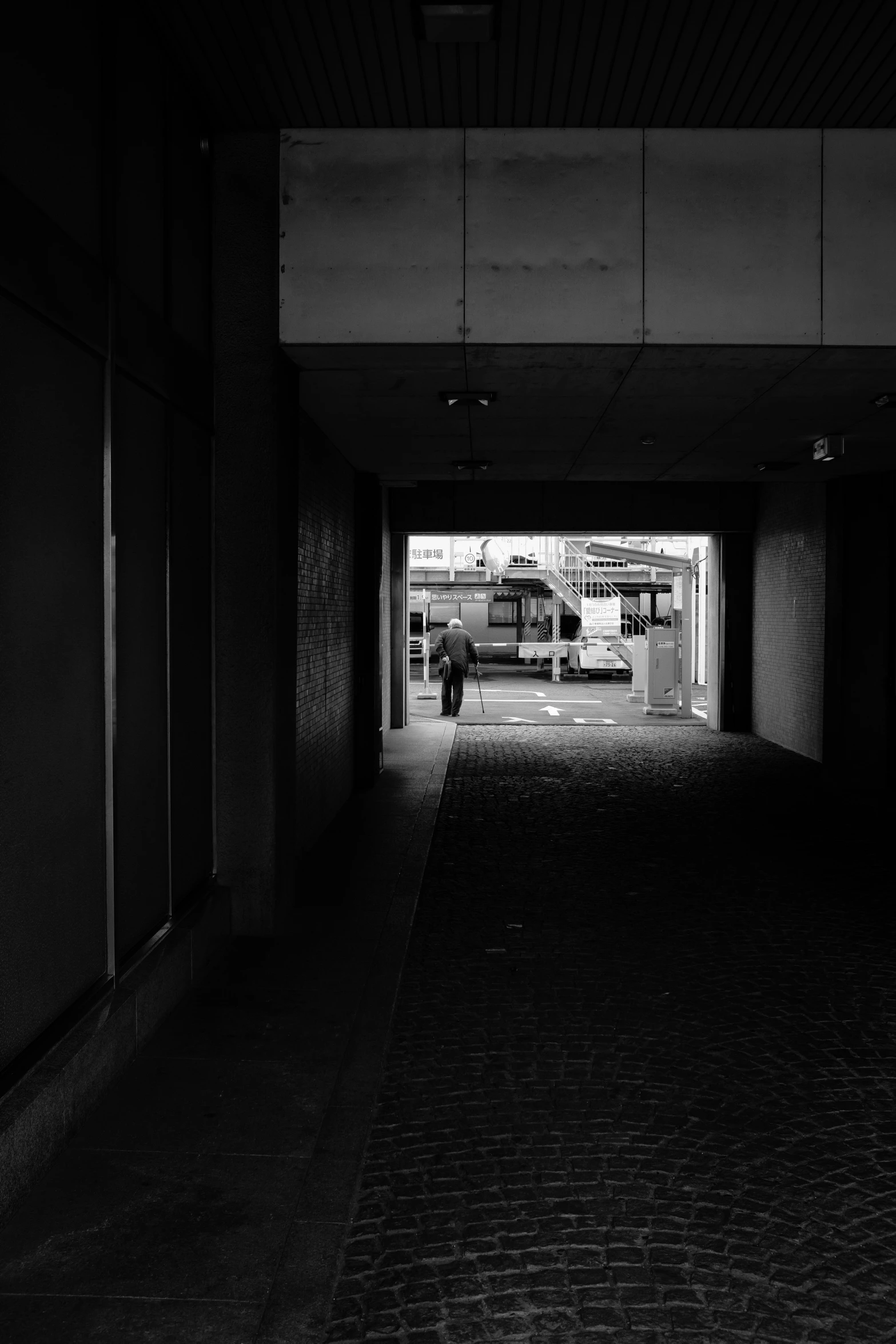 there is a large brick road that passes under the building