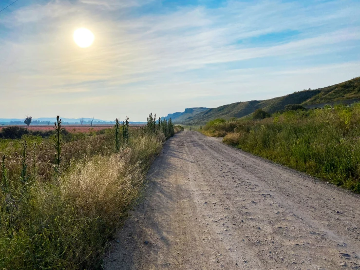 a dirt road that is in between two hills