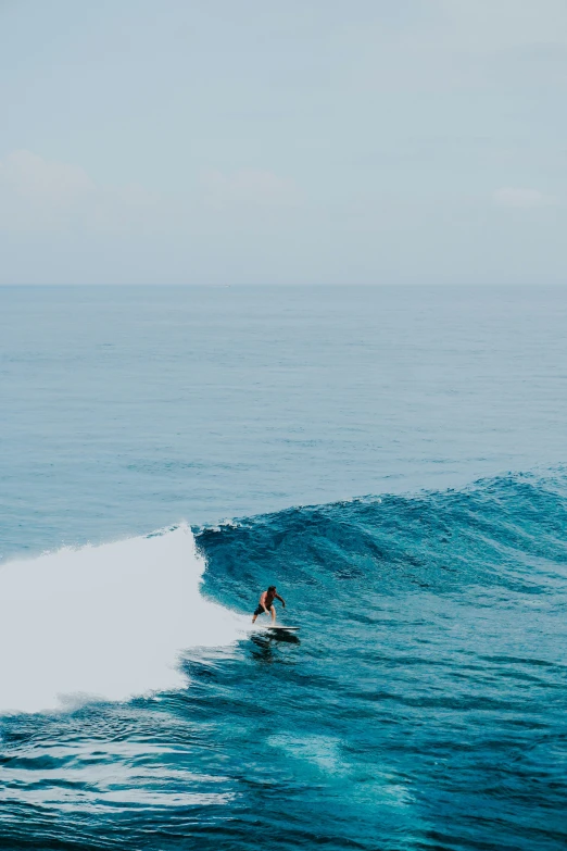 a man is surfing on the ocean waves