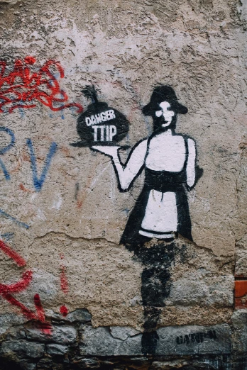 a graffiti shows a girl holding a sign in her hand
