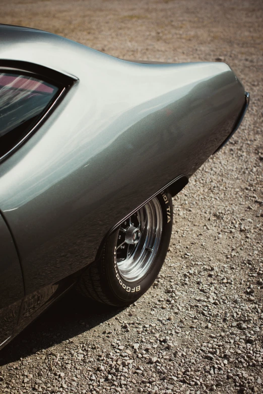 a vintage muscle car is parked in the street