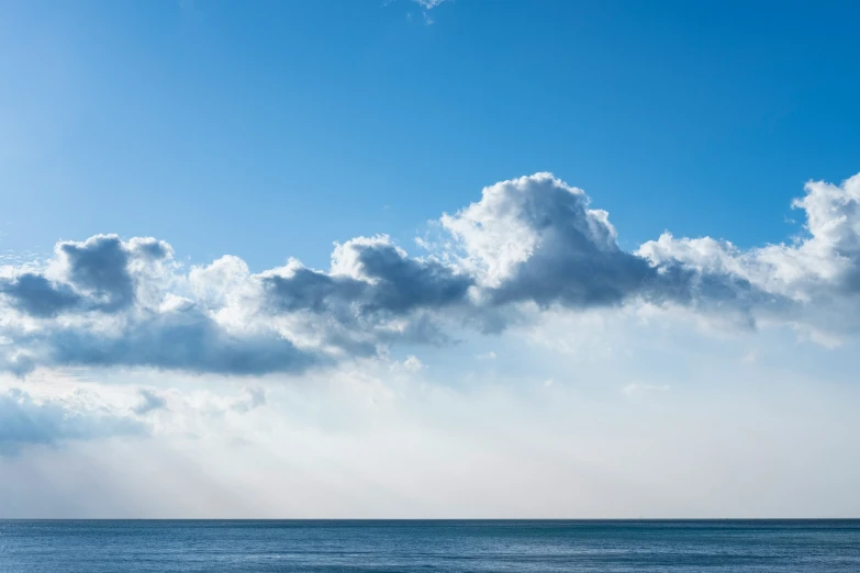 some people on the ocean and some clouds