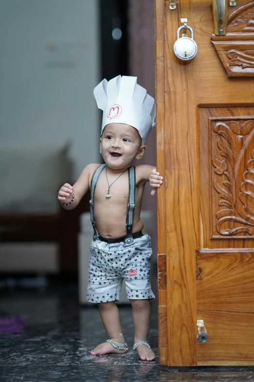 a baby boy with a chef's hat on his head
