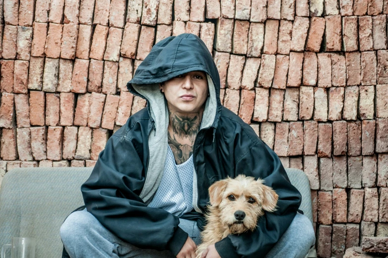 a man sitting down with his dog