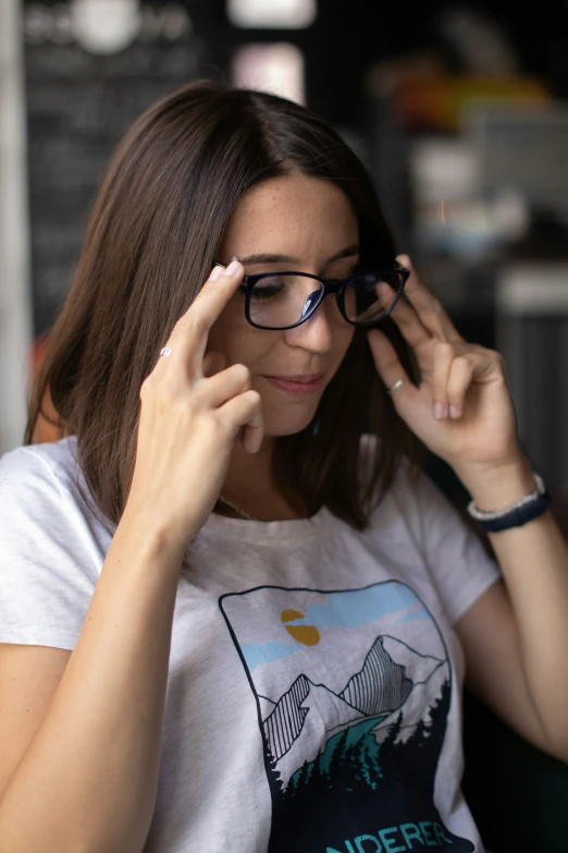 a girl with glasses looks through her eyeglasses