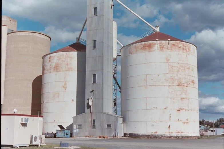 a large grain mill with two metal silos