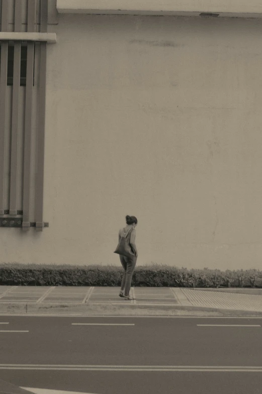 a woman is walking down the road outside