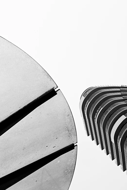 black and white pograph of large building with curved window