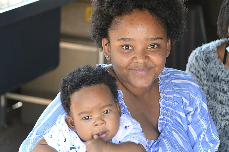 a woman with a little girl sitting on her lap