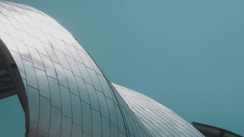 the curved sides of a building against a blue sky