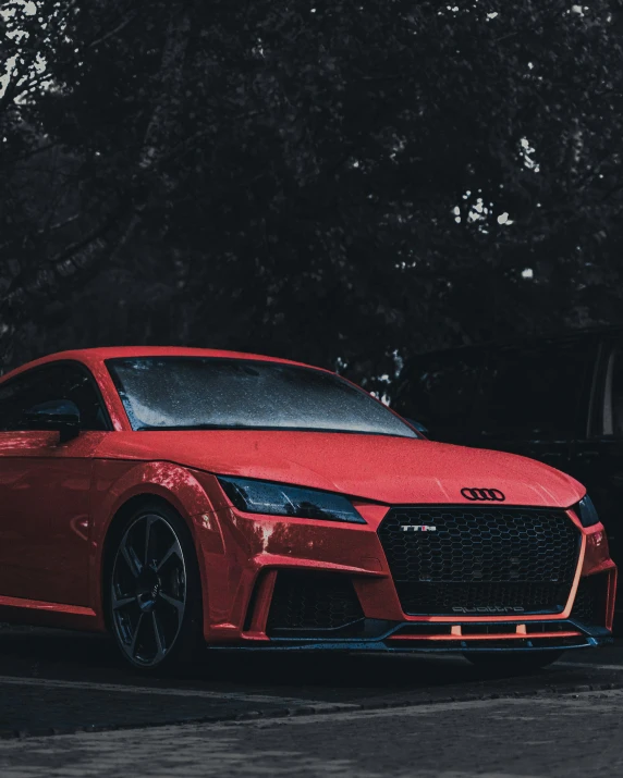 red sports car is parked on the road