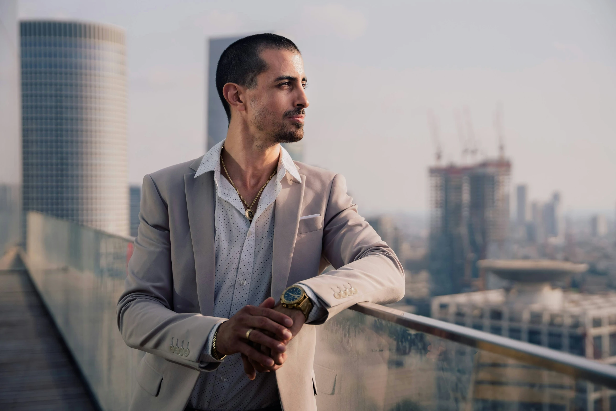 the man is posing for a picture while standing on a balcony