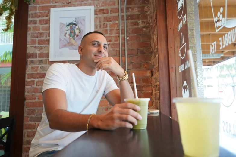 a man sits with his hands on his chin