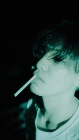 a  with his mouth open is holding a cigarette in one hand
