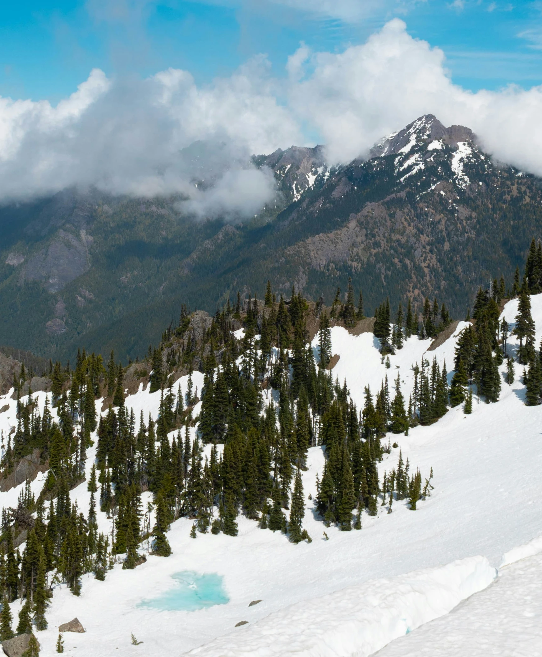 two people hiking up a snowy mountain in the snow