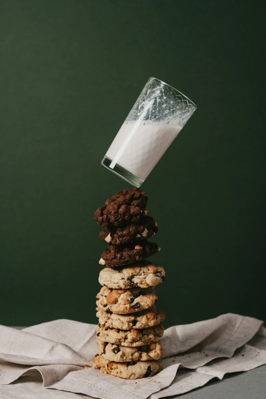 a stack of cookies, milk and some napkins