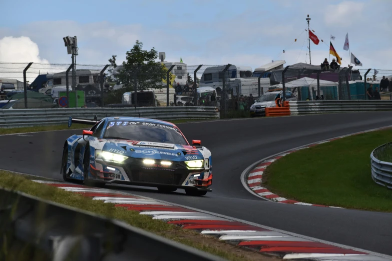 a car on a track near a grassy field