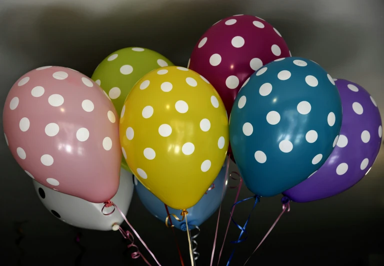 multi - color polka dots balloons arranged in a row