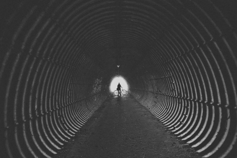 tunnel that seems to be made of cement and has a bench