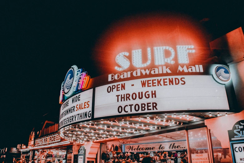 a large building with signs lit up on it