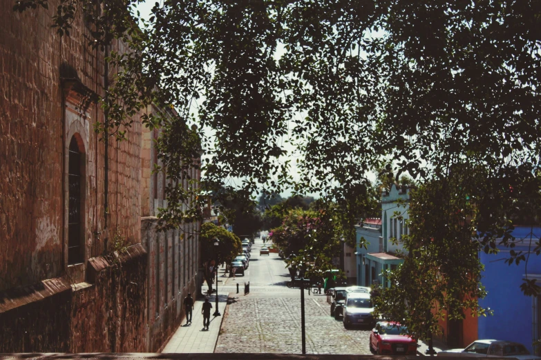 a narrow street and some cars parked on either side