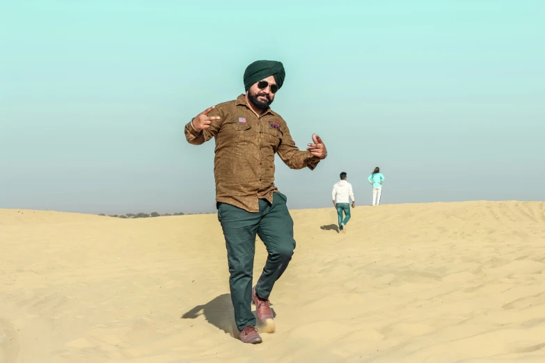 a man standing in the middle of some sand