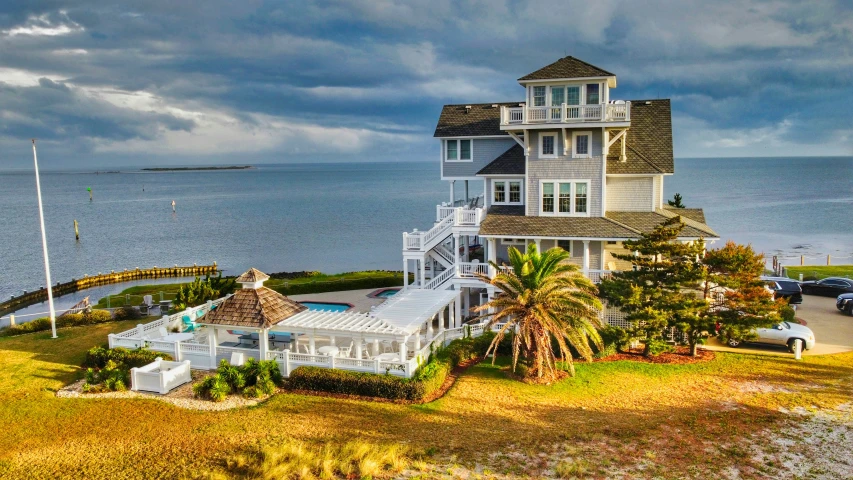 a two story house with an island in front