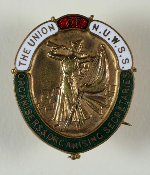 a badge that has a statue and a ribbon