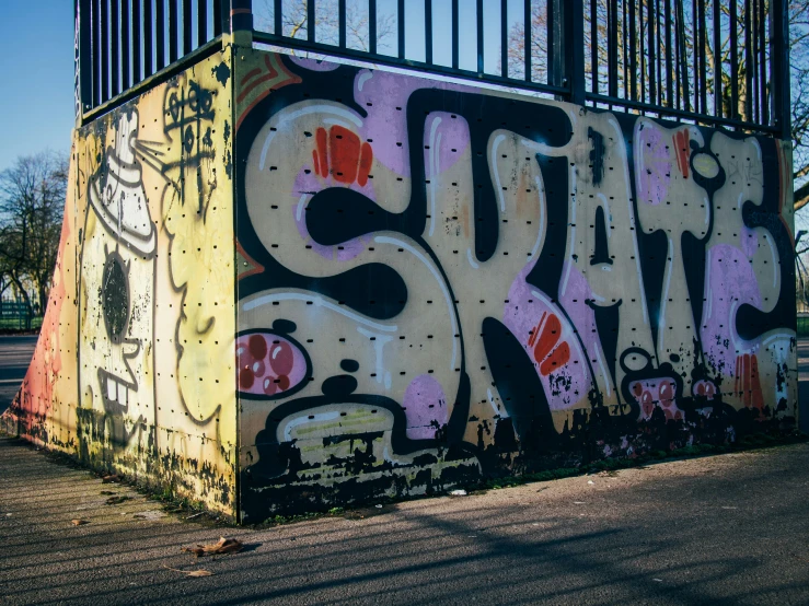 graffiti writing is written on a wall in a public area
