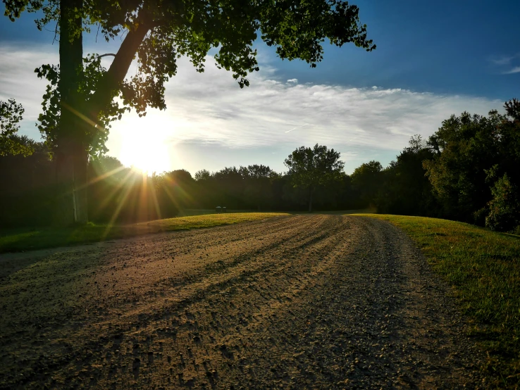 there is a small dirt road that goes into the sun