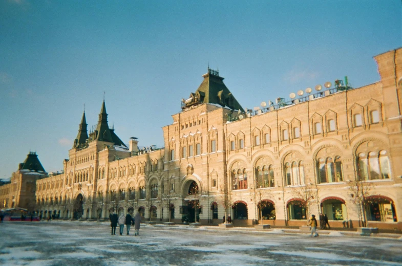 some people on the street outside a castle