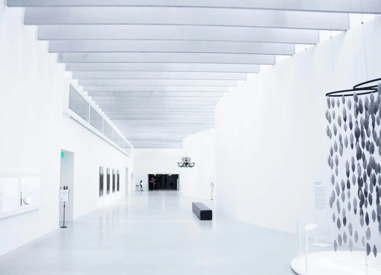 a long hallway lined with art sculptures on display