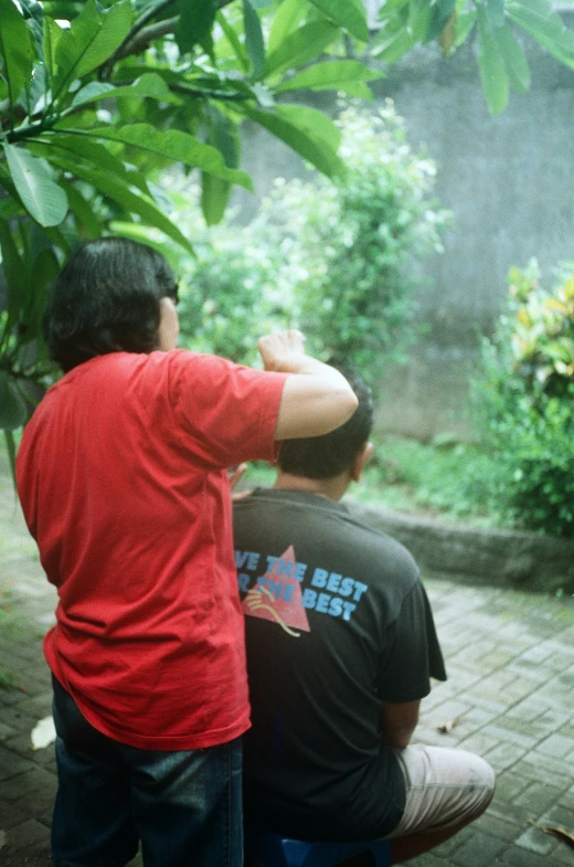 a couple of men are sitting down looking into the distance