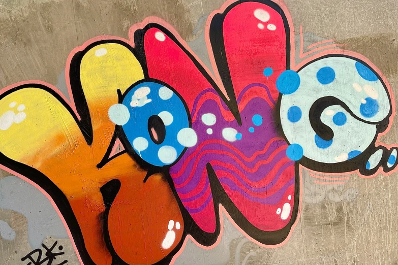 this is a colorful piece of graffiti on a wall