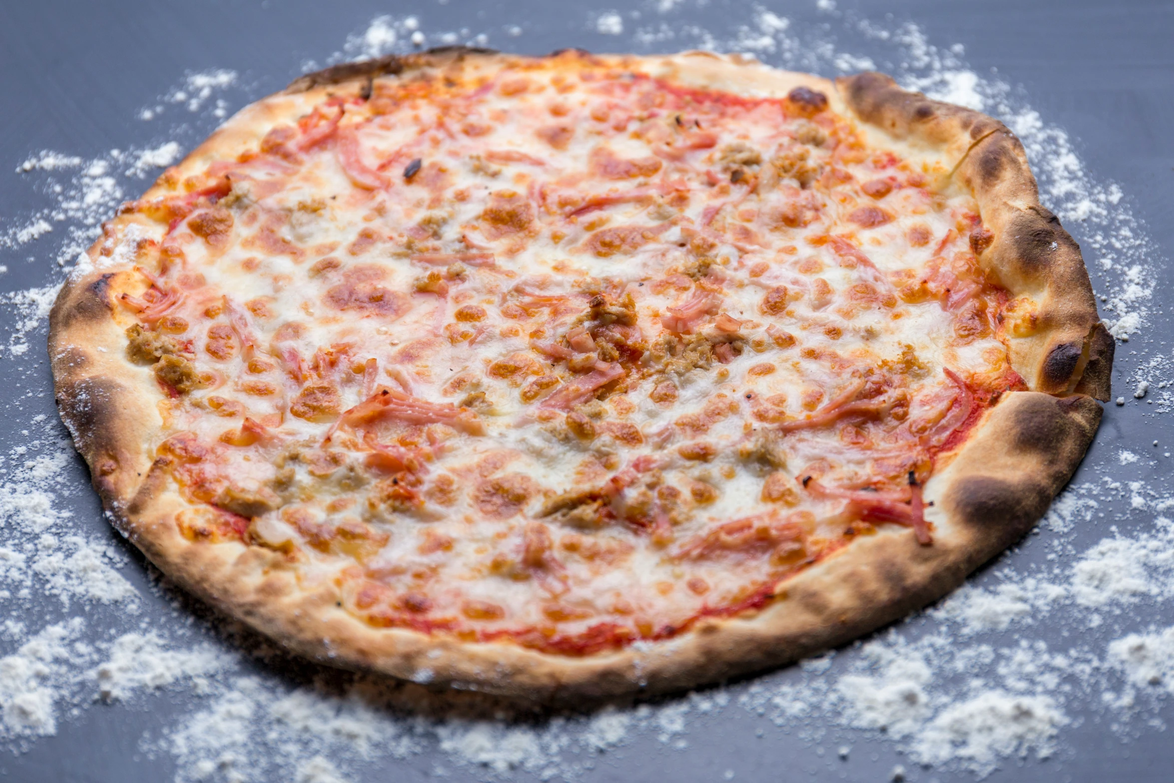 a small pizza sitting on top of some flour