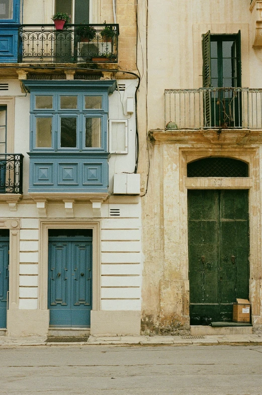 two tall buildings with balconies and a wooden balcony