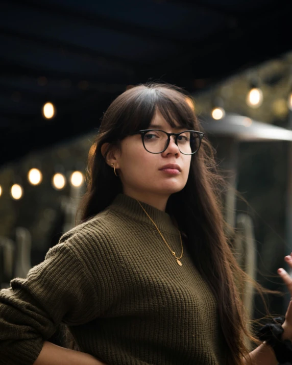 a young woman with a long, straight hair wearing glasses and talking on her cellphone