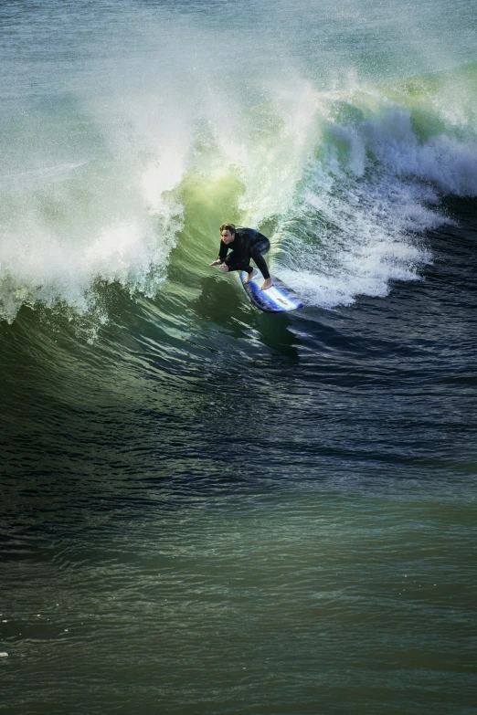 a person in a wetsuit riding a surf board