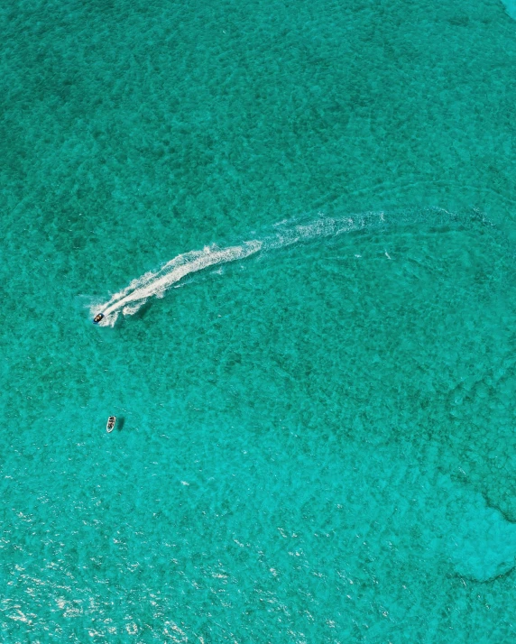 there is a boat on the water near a sailboat